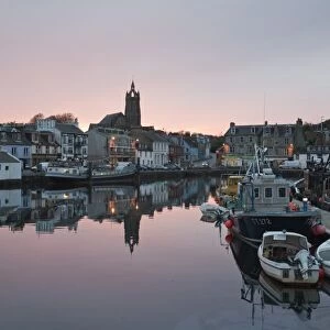 Boats moored in town harbour at sunset, Tarbert, Kintyre Peninsula, Loch Fyne, Argyll and Bute, Scotland, october