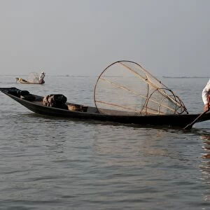 Traditional fishermen with fish traps in boats, Inle Lake, Shan State, Myanmar, January