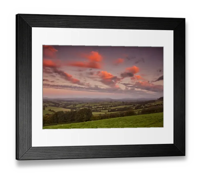 Framed Print : View of farmland with sheep flock grazing in pasture at sunrise, with Sugarloaf and Abergavenny in distance Framed Print : View of farmland with sheep flock grazing in pasture at sunrise, with Sugarloaf and Abergavenny in distance