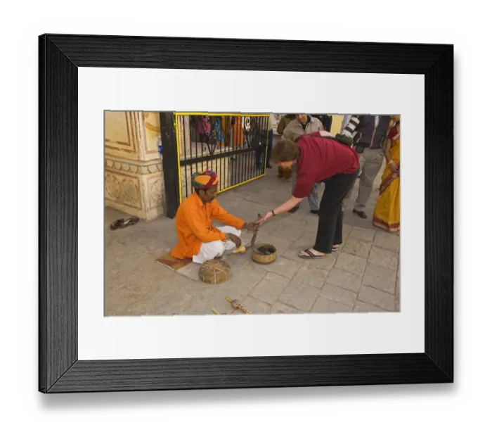 Framed Print : Snake charmer with cobra, with tourist on street in city, Jaipur, Rajasthan, India, December Framed Print : Snake charmer with cobra, with tourist on street in city, Jaipur, Rajasthan, India, December