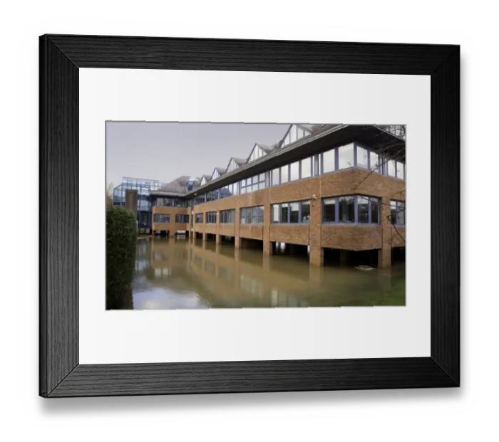 Framed Print : Office block built on floodplain with brick stilts to keep structure above water level during flooding, Forest Row