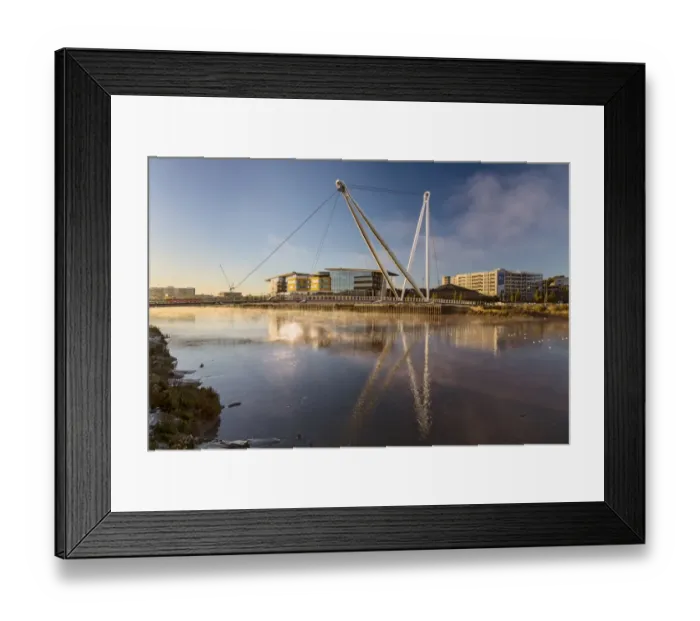Framed Print : View of tidal river with footbridge and university building at sunrise, Newport City Footbridge, River Usk, Newport Framed Print : View of tidal river with footbridge and university building at sunrise, Newport City Footbridge, River Usk, Newport
