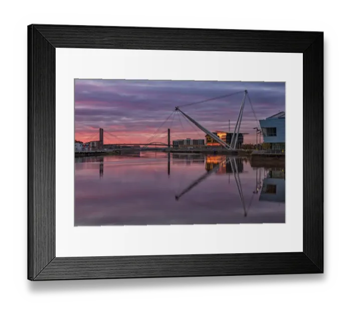 Framed Print : View of tidal river with footbridge and university building at sunrise, Newport City Footbridge, River Usk, Newport Framed Print : View of tidal river with footbridge and university building at sunrise, Newport City Footbridge, River Usk, Newport