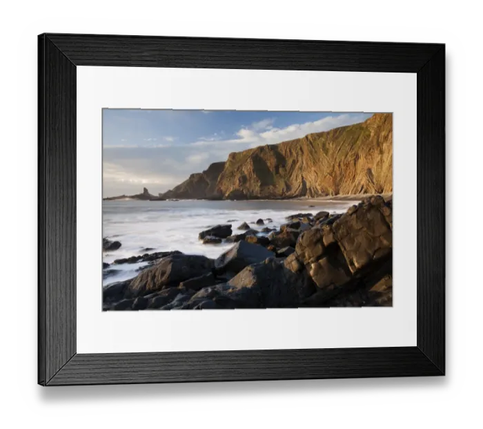 Framed Print : View of coastal cliff with folded strata in evening sunlight, Warren Cliff, Hartland, North Devon, England, April