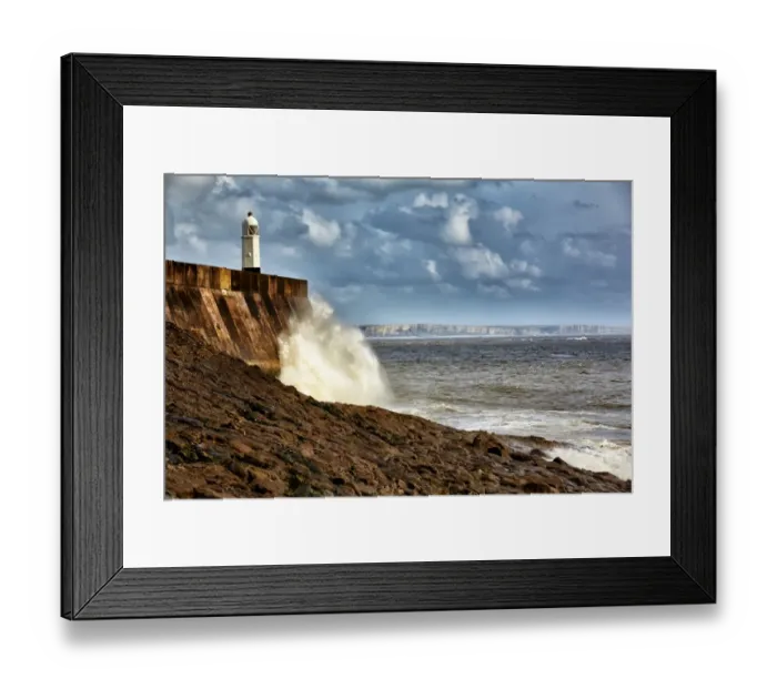 Framed Print : Waves crashing against coastal resort town seafront and lighthouse, Porthcawl Pier, Porthcawl, Bristol Channel