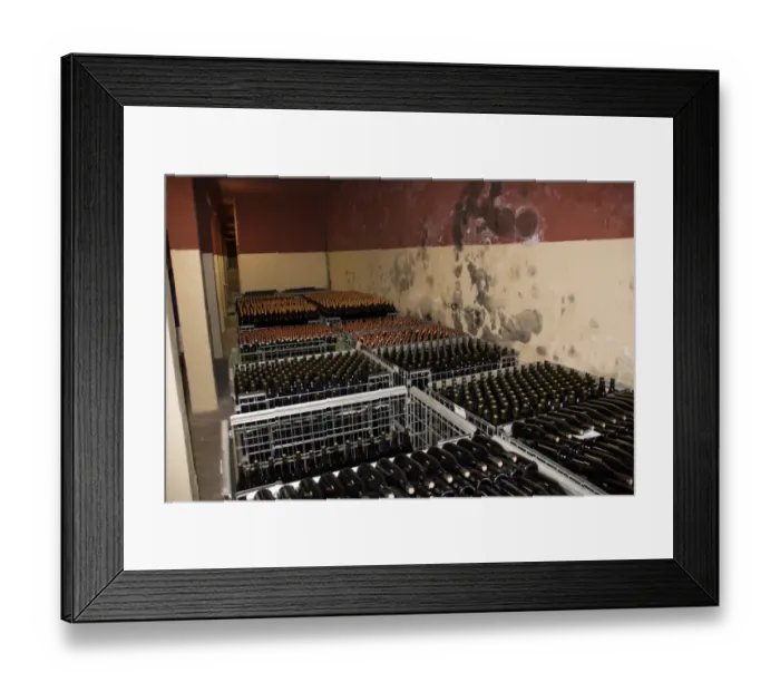 Framed Print : The wine cellar of Guasti Clemente with bottles of wine waiting to be labelled