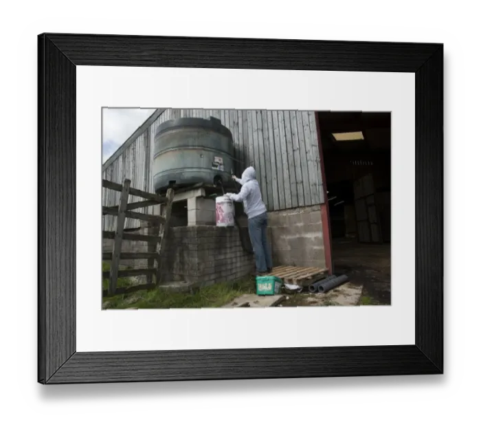 Framed Print : Man wearing hoodie, about to steal diesel from tank in farmyard, Lancashire, England, August Framed Print : Man wearing hoodie, about to steal diesel from tank in farmyard, Lancashire, England, August