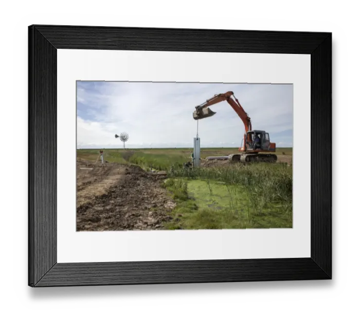 Framed Print : Metal pilings being fitting to make a sluice gate to retain water at Deepdale Marsh, Burnham Deepdale, North Norfolk