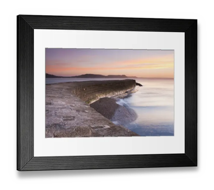 Framed Print : View of harbour wall at low tide during sunrise, looking across bay to Charmouth, Stonebarrow, Golden Cap and beyond Framed Print : View of harbour wall at low tide during sunrise, looking across bay to Charmouth, Stonebarrow, Golden Cap and beyond
