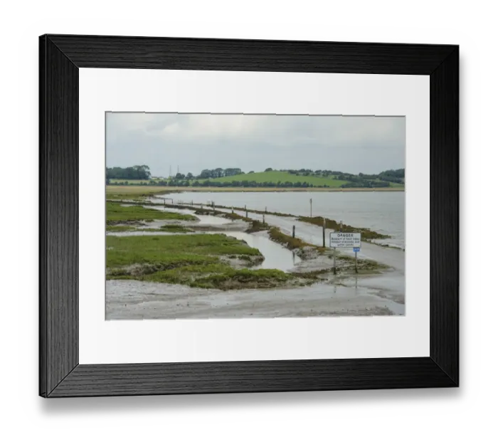 Framed Print : Danger, Beware of fast tides, hidden channels and quick sands warning sign beside road from coastal village Framed Print : Danger, Beware of fast tides, hidden channels and quick sands warning sign beside road from coastal village