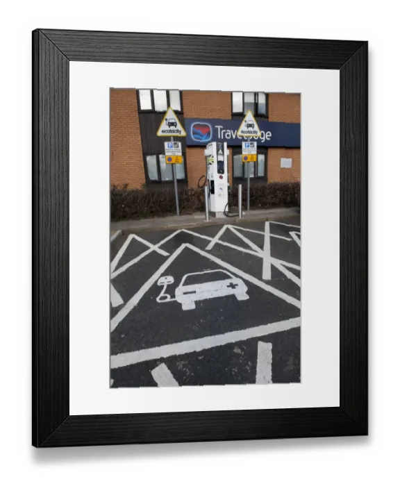 Framed Print : Reserved parking bay at recharging point for electric cars at motorway service area, England, April Framed Print : Reserved parking bay at recharging point for electric cars at motorway service area, England, April