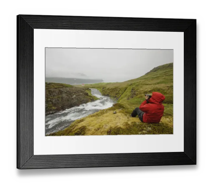 Framed Print : Hiker using binoculars, sitting beside river and coastline with low cloud, Hornstrandir, Westfjords, Iceland, July Framed Print : Hiker using binoculars, sitting beside river and coastline with low cloud, Hornstrandir, Westfjords, Iceland, July