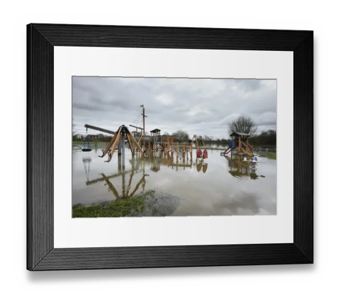 Framed Print : Floodwater in playground during river flood, River Thames, Chertsey, Surrey, England, February 2014 Framed Print : Floodwater in playground during river flood, River Thames, Chertsey, Surrey, England, February 2014