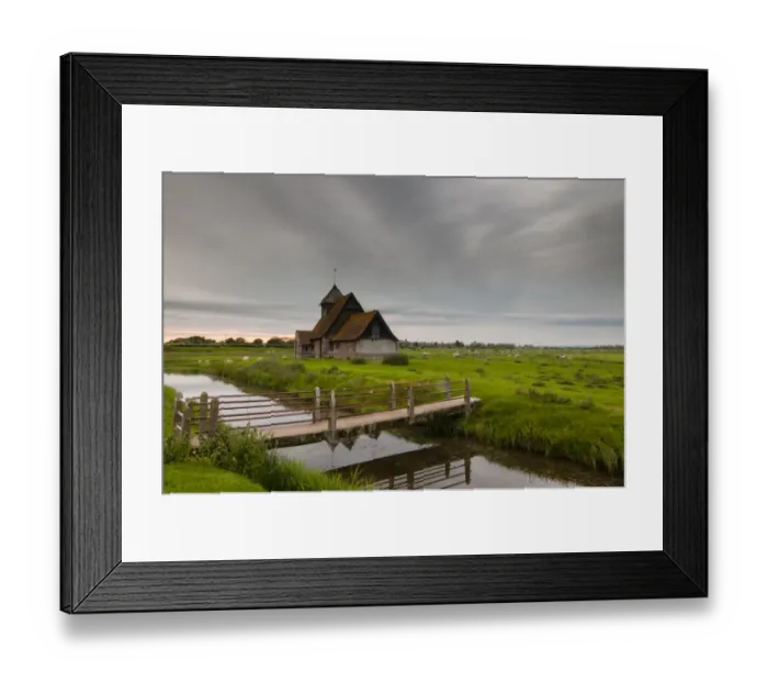 Framed Print : View of sheep on grazing marsh with footbridge across flooded ditch and church in evening, St Framed Print : View of sheep on grazing marsh with footbridge across flooded ditch and church in evening, St