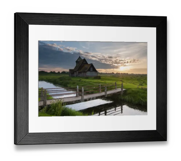 Framed Print : View of grazing marsh with footbridge across flooded ditch and church at sunset, St Framed Print : View of grazing marsh with footbridge across flooded ditch and church at sunset, St