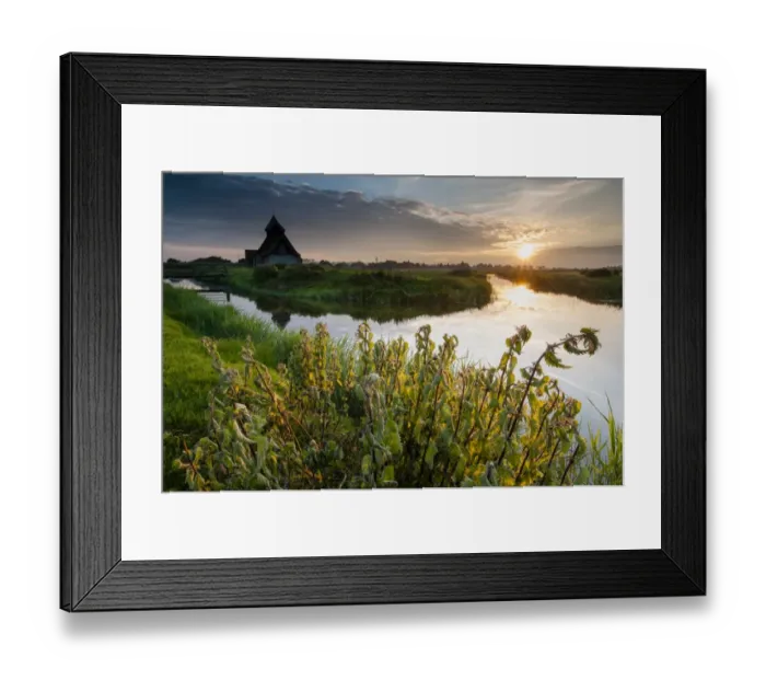 Framed Print : View of grazing marsh with Stinging Nettle (Urtica (Urtica dioica) patch and church beside flooded ditch at sunset, St