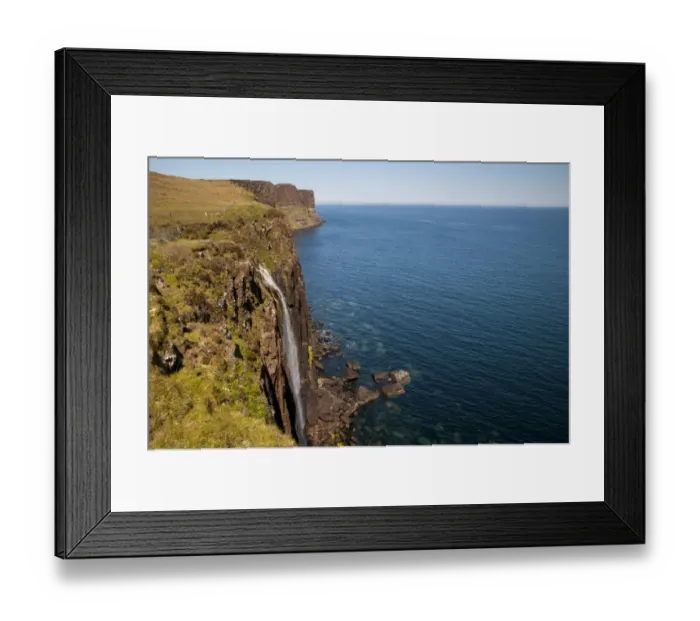 Framed Print : View of coastline with waterfall tumbling over cliffs into sea, with Kilt Rock in background, Mealt Falls