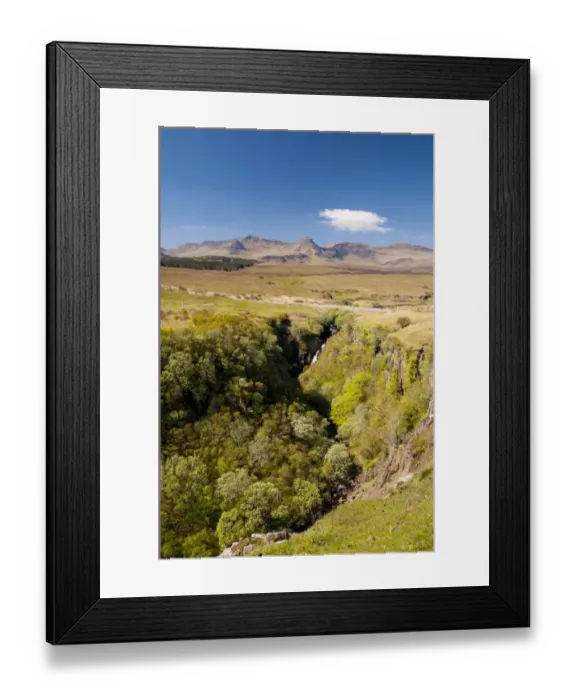 Framed Print : View of waterfall tumbling into wooded ravine, with hills of Trotternish Ridge in background, Lealt River, An Lethallt
