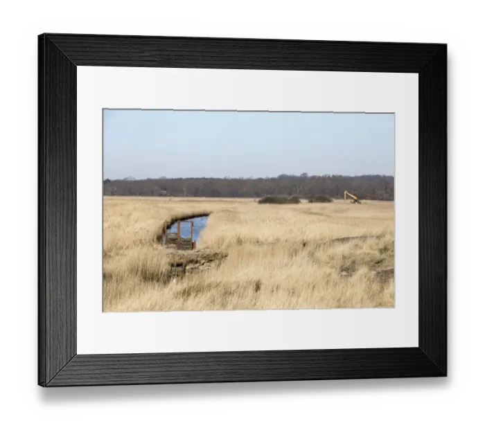 Framed Print : Looking west towards Bittern Hide over reeds and a dyke. Also digger used for maintaining the marshland habitat