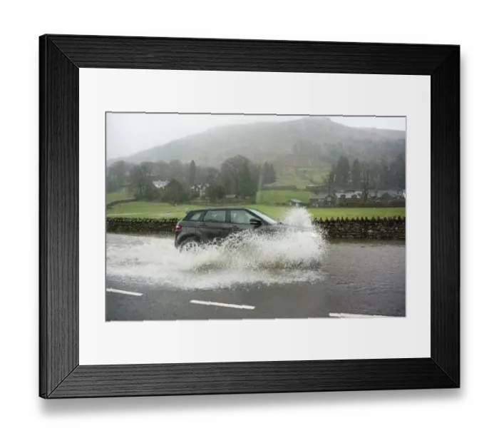 Framed Print : Car driving through floodwater on road during heavy rainfall, A591, Grasmere, Lake District, Cumbria, England, December