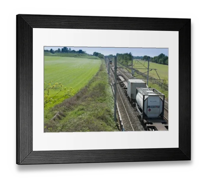 Framed Print : Frieght train travelling through farmland, Goostrey, Cheshire, England, april Framed Print : Frieght train travelling through farmland, Goostrey, Cheshire, England, april