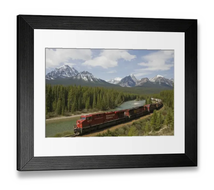 Framed Print : Canadian Pacific railway train travelling along track, with range of mountains in background, Bow Range, Morant's Curve, Banff N. P. Rocky Mountains, Alberta, Canada, june Framed Print : Canadian Pacific railway train travelling along track, with range of mountains in background, Bow Range, Morant's Curve, Banff N. P. Rocky Mountains, Alberta, Canada, june