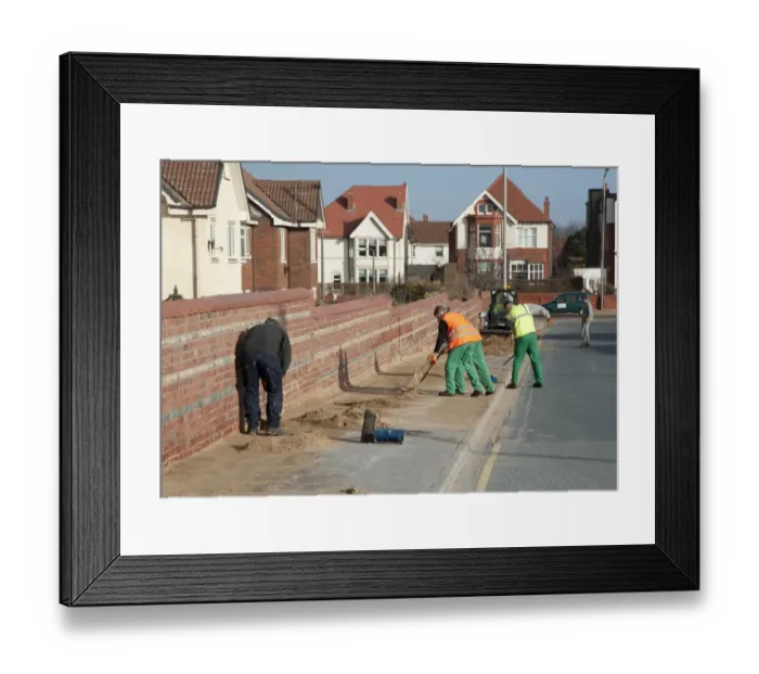 Framed Print : Council workers clearing away sand blown from beach and dunes onto road and pavement in seaside resort town, Lytham St. Anne's, Lancashire, England, january Framed Print : Council workers clearing away sand blown from beach and dunes onto road and pavement in seaside resort town, Lytham St. Anne's, Lancashire, England, january
