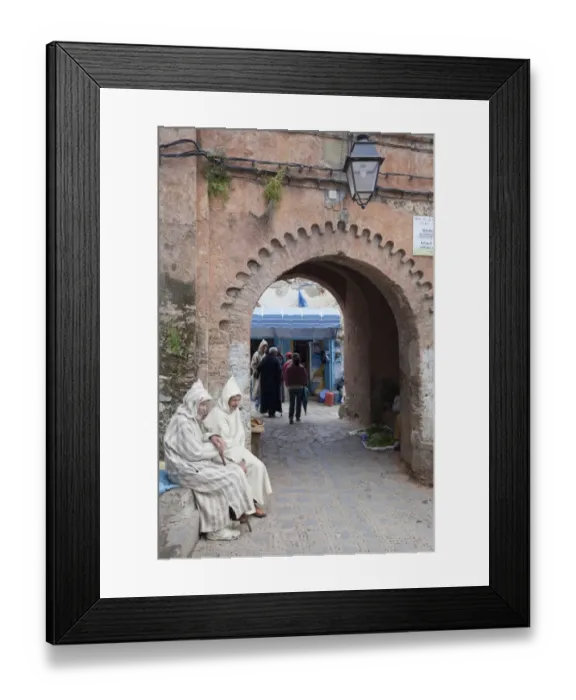 Framed Print : Men wearing djellaba sitting beside medina archway in city, Chefchaouen, Morocco, april