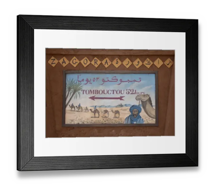 Framed Print : Tombouctou 52 days direction sign in desert town, Zagora, Sahara, Morocco, may Framed Print : Tombouctou 52 days direction sign in desert town, Zagora, Sahara, Morocco, may