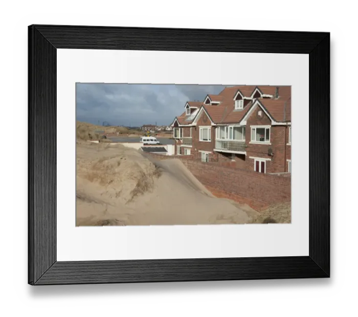 Framed Print : Sand blown from beach forming dunes building up against garden wall next to houses in seaside resort town, Lytham St. Anne's, Lancashire, England, january Framed Print : Sand blown from beach forming dunes building up against garden wall next to houses in seaside resort town, Lytham St. Anne's, Lancashire, England, january