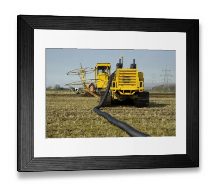 Framed Print : Field drainage, continuous pipe laying machine working in arable field, Pilling, Lancashire, England, march Framed Print : Field drainage, continuous pipe laying machine working in arable field, Pilling, Lancashire, England, march