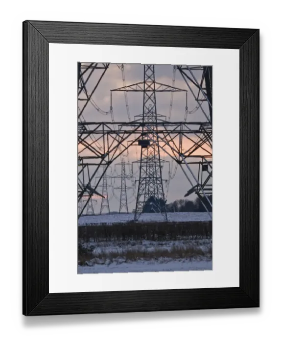 Framed Print : Electricity transmission pylons and overhead wires, crossing over snow covered farmland at sunset, Dorset, England, december Framed Print : Electricity transmission pylons and overhead wires, crossing over snow covered farmland at sunset, Dorset, England, december