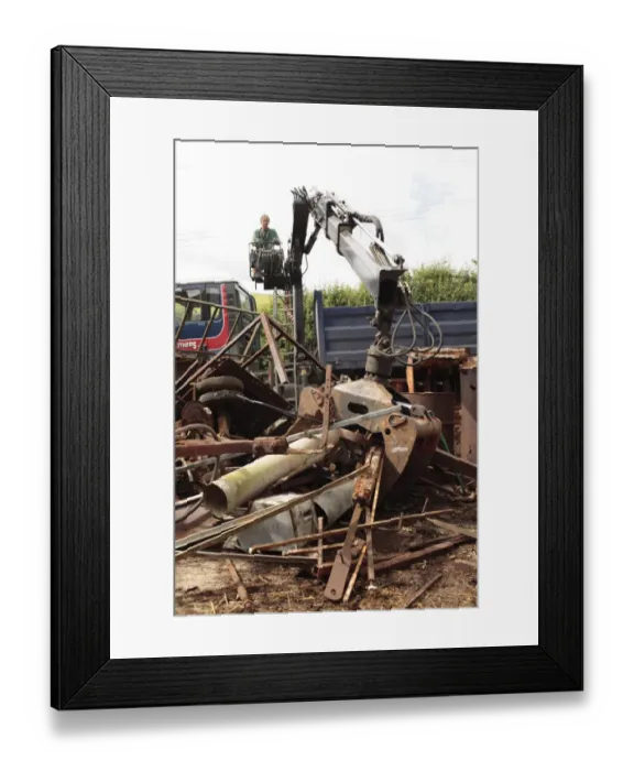 Framed Print : Metal recycler collecting assorted scrap metal with mechanical grabber on farm, Powys, Wales, july Framed Print : Metal recycler collecting assorted scrap metal with mechanical grabber on farm, Powys, Wales, july