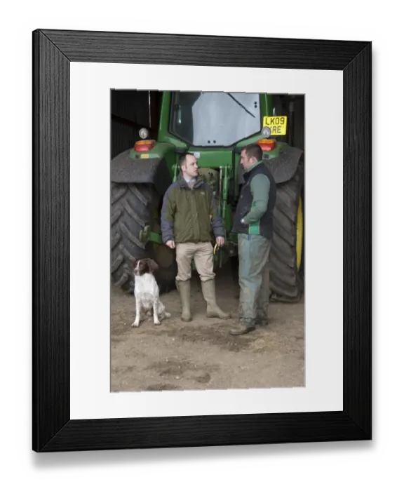 Framed Print : Agronomist discussing program for day with farmer, standing beside tractor, Hertfordshire, England, april Framed Print : Agronomist discussing program for day with farmer, standing beside tractor, Hertfordshire, England, april