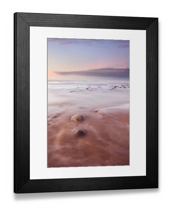 Framed Print : View of pebbles on beach with incoming tide at sunset, Westward Ho!, North Devon, England, january Framed Print : View of pebbles on beach with incoming tide at sunset, Westward Ho!, North Devon, England, january