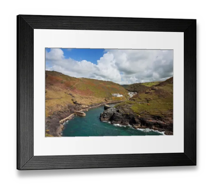 Framed Print : View of coastline with breakwater and old quay in foreground leading to village in valley, Bossington Harbour Framed Print : View of coastline with breakwater and old quay in foreground leading to village in valley, Bossington Harbour