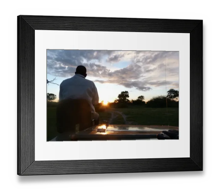 Framed Print : Spotter sitting at front of safari vehicle at dusk, Okavango Delta, Botswana Framed Print : Spotter sitting at front of safari vehicle at dusk, Okavango Delta, Botswana