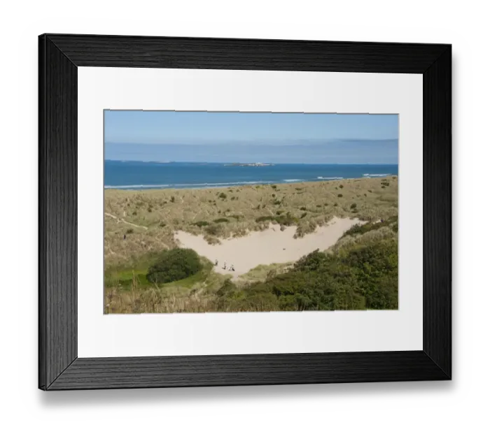 Framed Print : View of coastline with sand dunes, looking towards distant Farne Islands, Bamburgh, Northumberland, England, july Framed Print : View of coastline with sand dunes, looking towards distant Farne Islands, Bamburgh, Northumberland, England, july