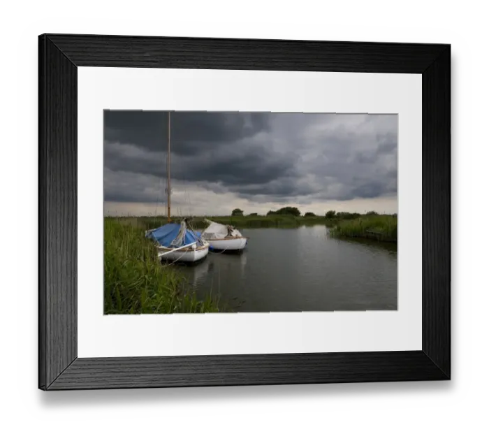 Framed Print : Boats moored under stormclouds, River Thurne, The Broads N. P. Norfolk, England, may Framed Print : Boats moored under stormclouds, River Thurne, The Broads N. P. Norfolk, England, may