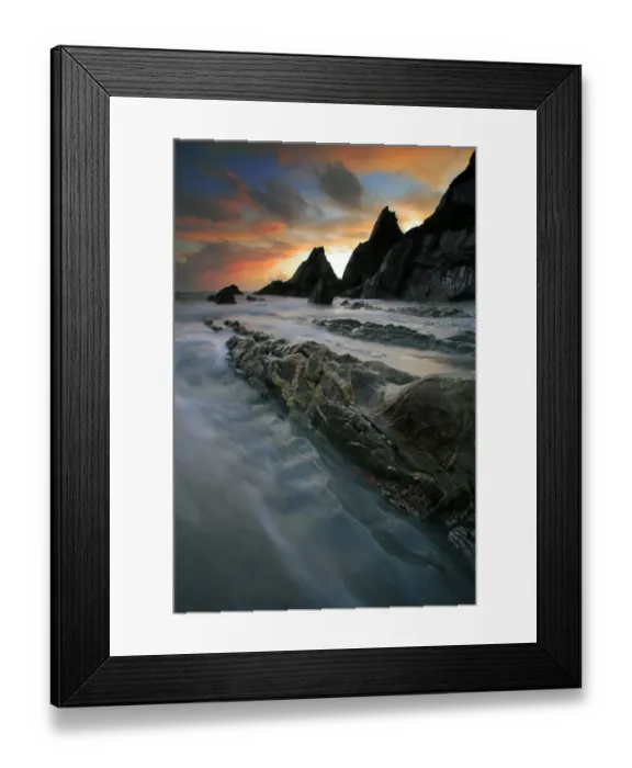 Framed Print : View of eroded rock formations on beach in sandy cove at sunset, Westcombe Beach, near Bigbury, Devon, England Framed Print : View of eroded rock formations on beach in sandy cove at sunset, Westcombe Beach, near Bigbury, Devon, England