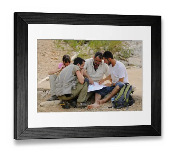 Framed Print : Researchers looking at map in desert, Socotra, Yemen, march Framed Print : Researchers looking at map in desert, Socotra, Yemen, march
