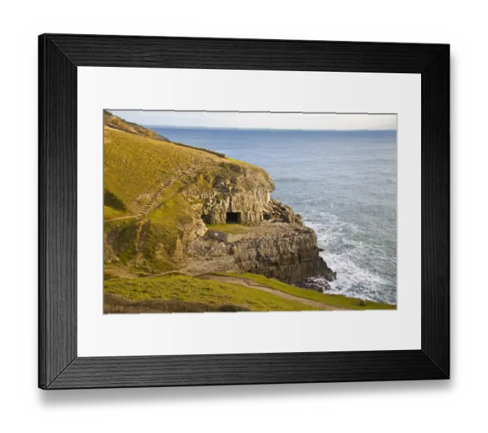 Framed Print : View of coastline with manmade caves in cliff, former Purbeck Stone limestone quarry, Tilly Whim Caves, Durlston