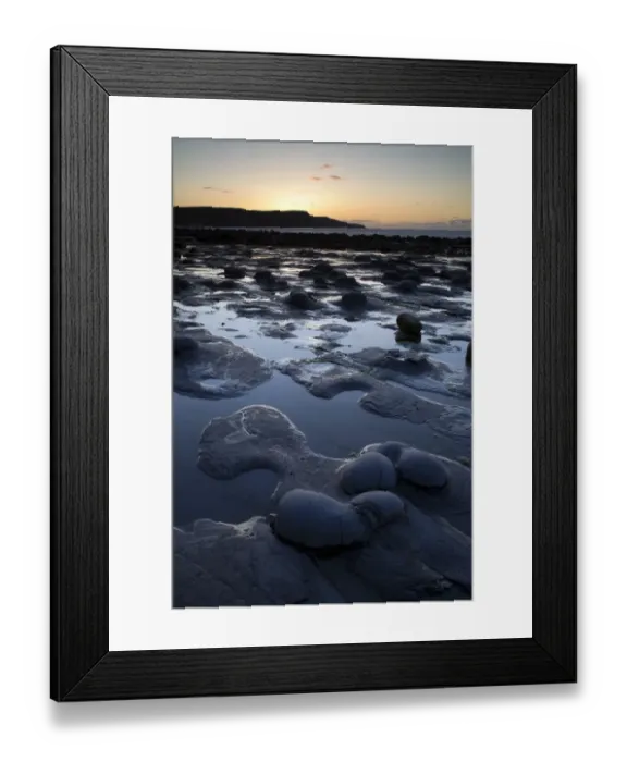 Framed Print : View of rocky beach at sunset, Runswick Bay, North Yorkshire, England, may