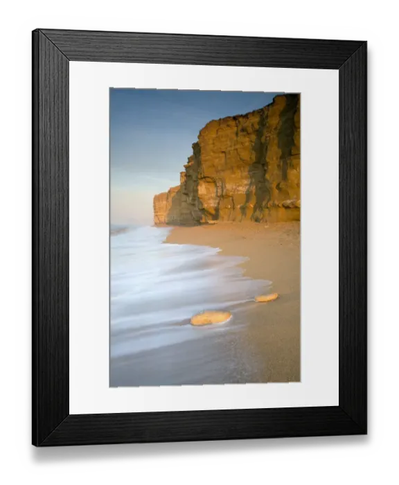 Framed Print : View of sandy beach and sea cliffs, Jurassic cliffs made from many layers of different material which erodes Framed Print : View of sandy beach and sea cliffs, Jurassic cliffs made from many layers of different material which erodes
