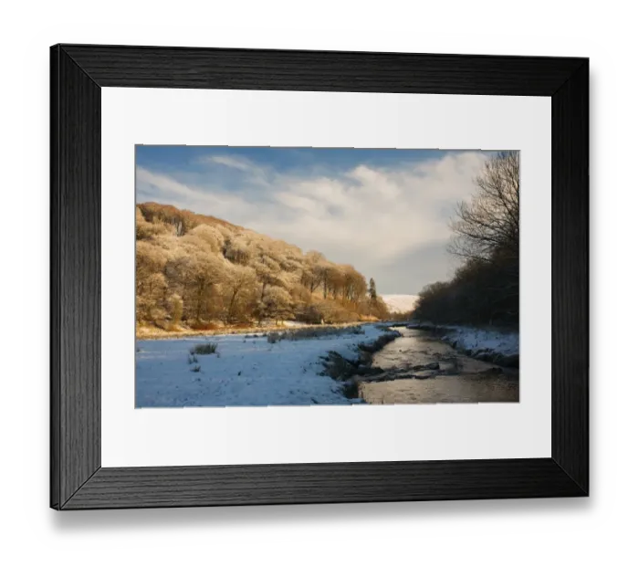 Framed Print : View of snow covered riverbank with trees in late afternoon sunshine, following Two Moors Way footpath Framed Print : View of snow covered riverbank with trees in late afternoon sunshine, following Two Moors Way footpath