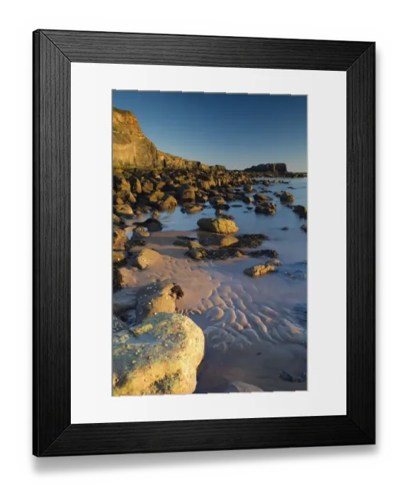 Framed Print : Rocks on beach with sea cliffs at sunrise, Saltwick Nab, Saltwick Bay, North Yorkshire, England, august Framed Print : Rocks on beach with sea cliffs at sunrise, Saltwick Nab, Saltwick Bay, North Yorkshire, England, august