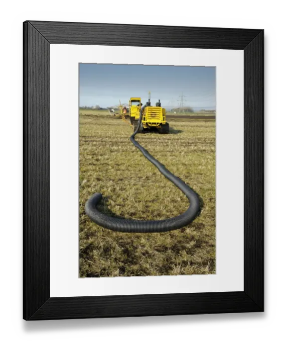 Framed Print : Field drainage, continuous pipe laying machine working in arable field, Pilling, Lancashire, England, march
