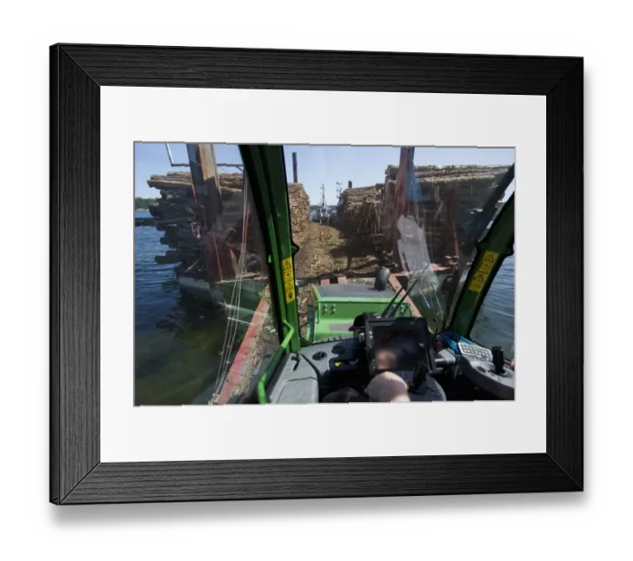 Framed Print : Interior of John Deere 1010E Forwarder loading logs onto timber barge, Archipelago Sea, Baltic Sea, Sweden, june Framed Print : Interior of John Deere 1010E Forwarder loading logs onto timber barge, Archipelago Sea, Baltic Sea, Sweden, june