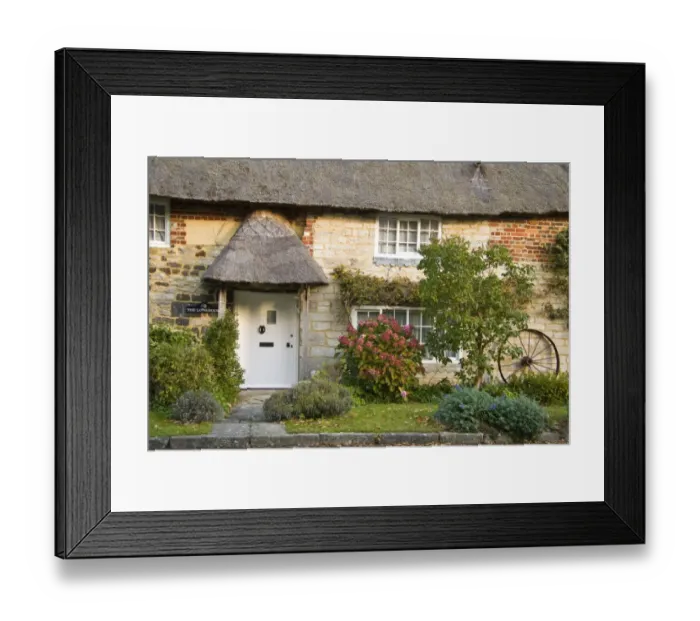 Framed Print : Thatched house with front garden and old wheel propped against wall, Dorset, England, october Framed Print : Thatched house with front garden and old wheel propped against wall, Dorset, England, october