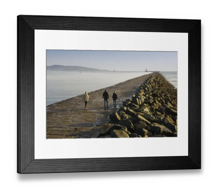 Framed Print : People walking on sea wall protecting harbour entrance, sea wall preventing sand encroachment from South Bull sandbank Framed Print : People walking on sea wall protecting harbour entrance, sea wall preventing sand encroachment from South Bull sandbank